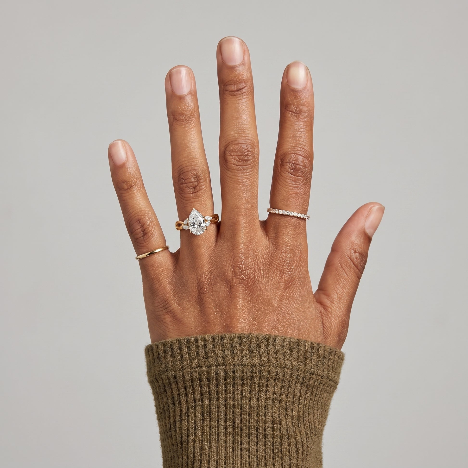 1.5 carat pear cut moissanite ring on finger 925 silver engagement ring