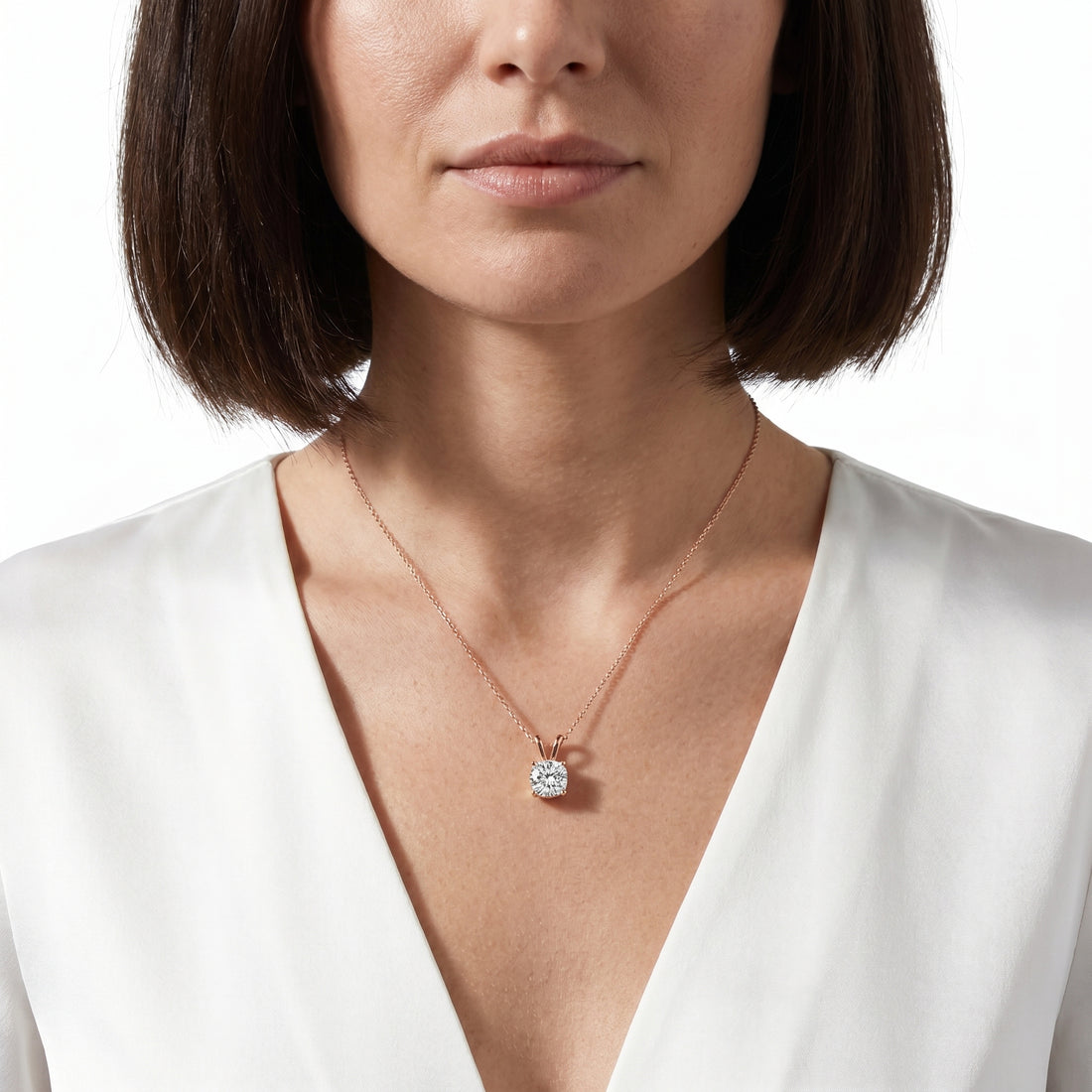 Close-up of 1 carat cushion cut moissanite pendant in sterling silver prong setting