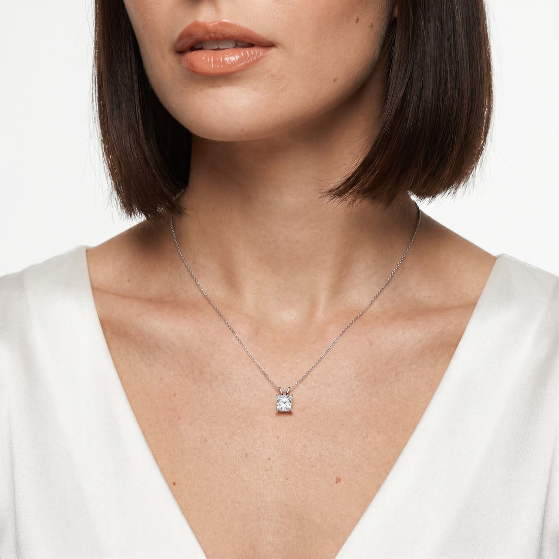 Close-up of 1 carat princess cut moissanite pendant in sterling silver prong setting