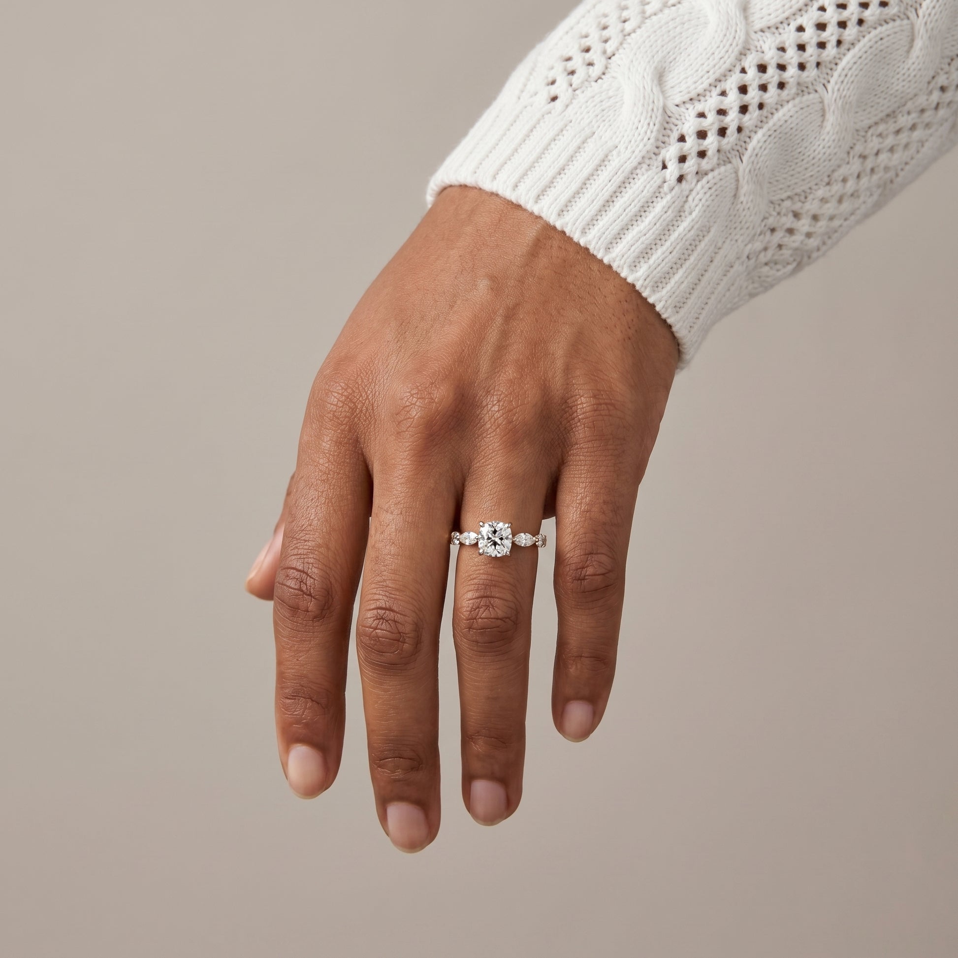 Cushion cut moissanite engagement ring in natural light with yellow gold band