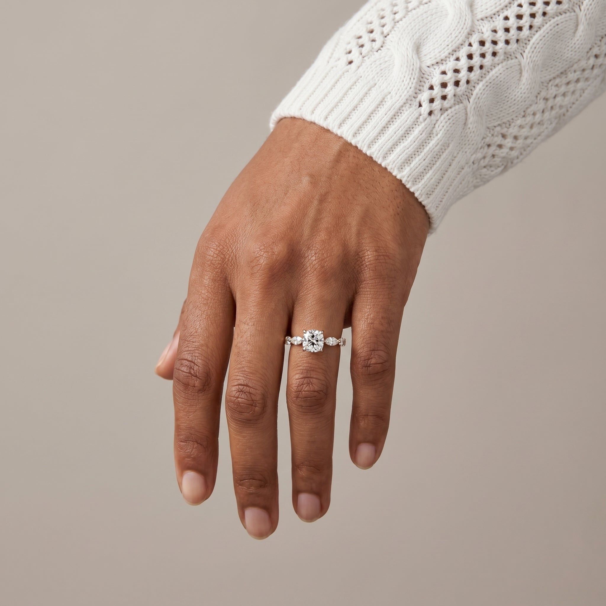 Cushion cut moissanite engagement ring in natural light with yellow gold band