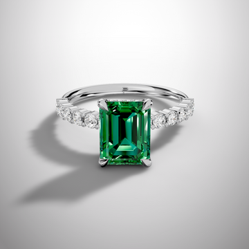 Emerald cut green moissanite ring with pavé band in 925 sterling silver front view
