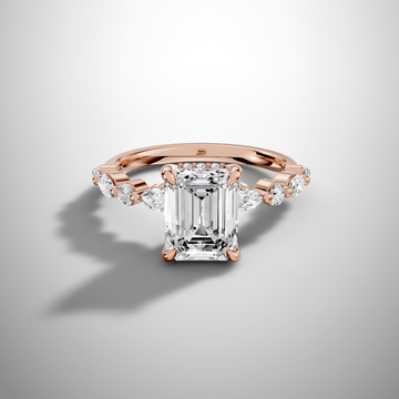 Emerald cut moissanite solitaire ring with hidden halo and side stones in yellow gold finish front view