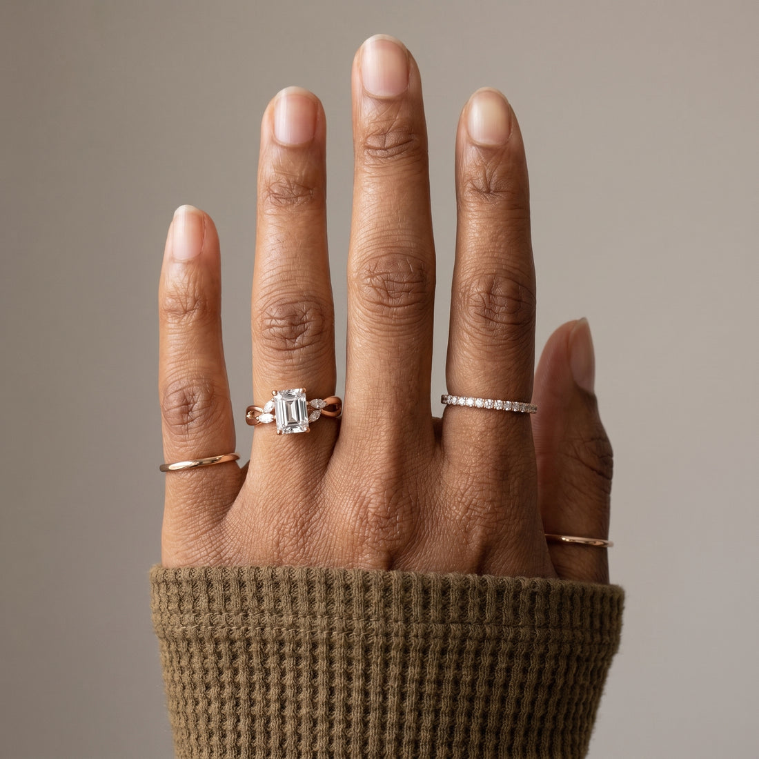 1.5 carat emerald cut moissanite infinity ring in 925 sterling silver front view