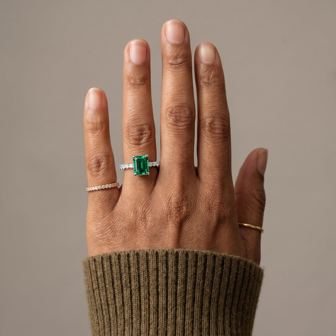 Emerald cut green moissanite ring with pavé band in 925 sterling silver front view
