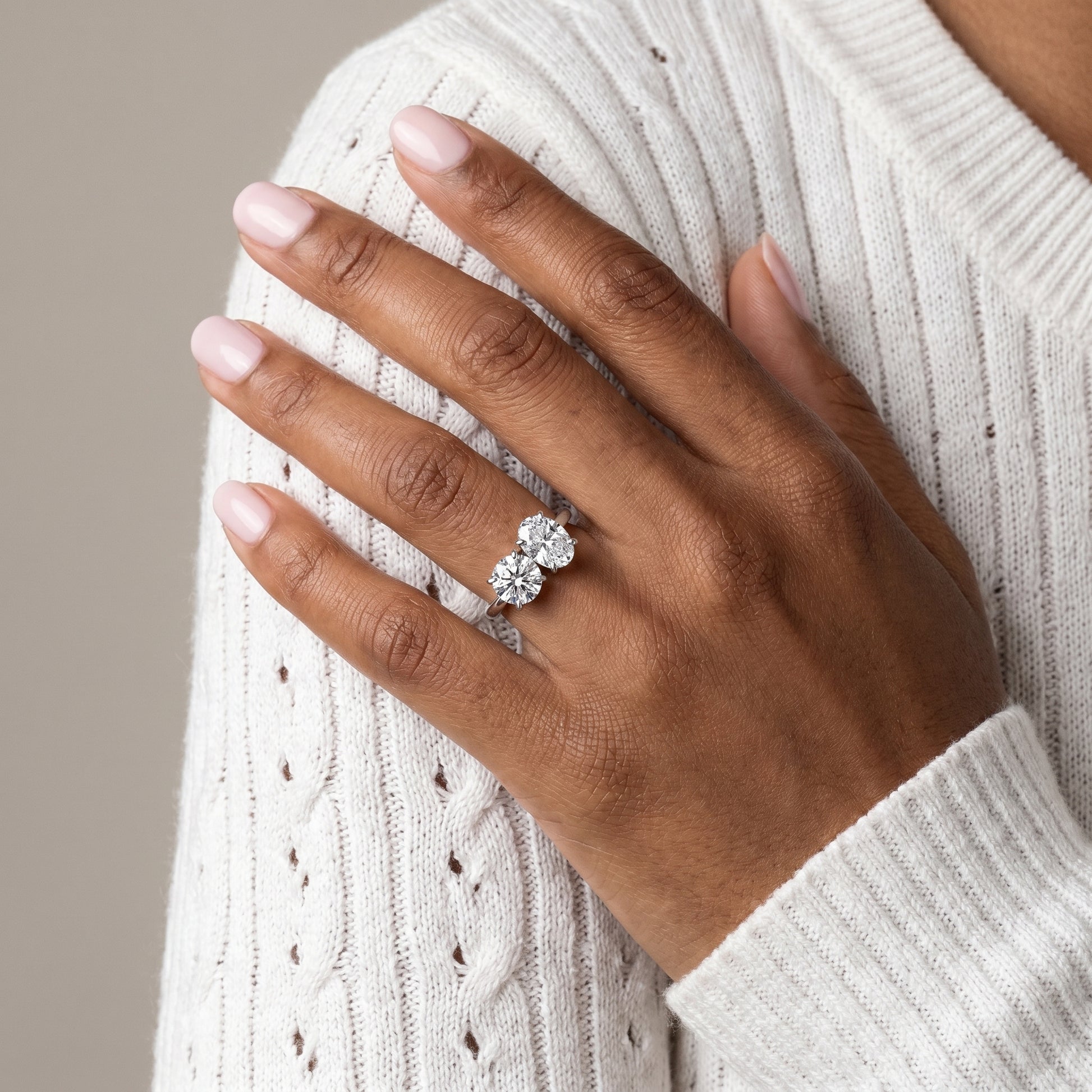 Close-up detail of dual stone moissanite ring prong setting oval and round
