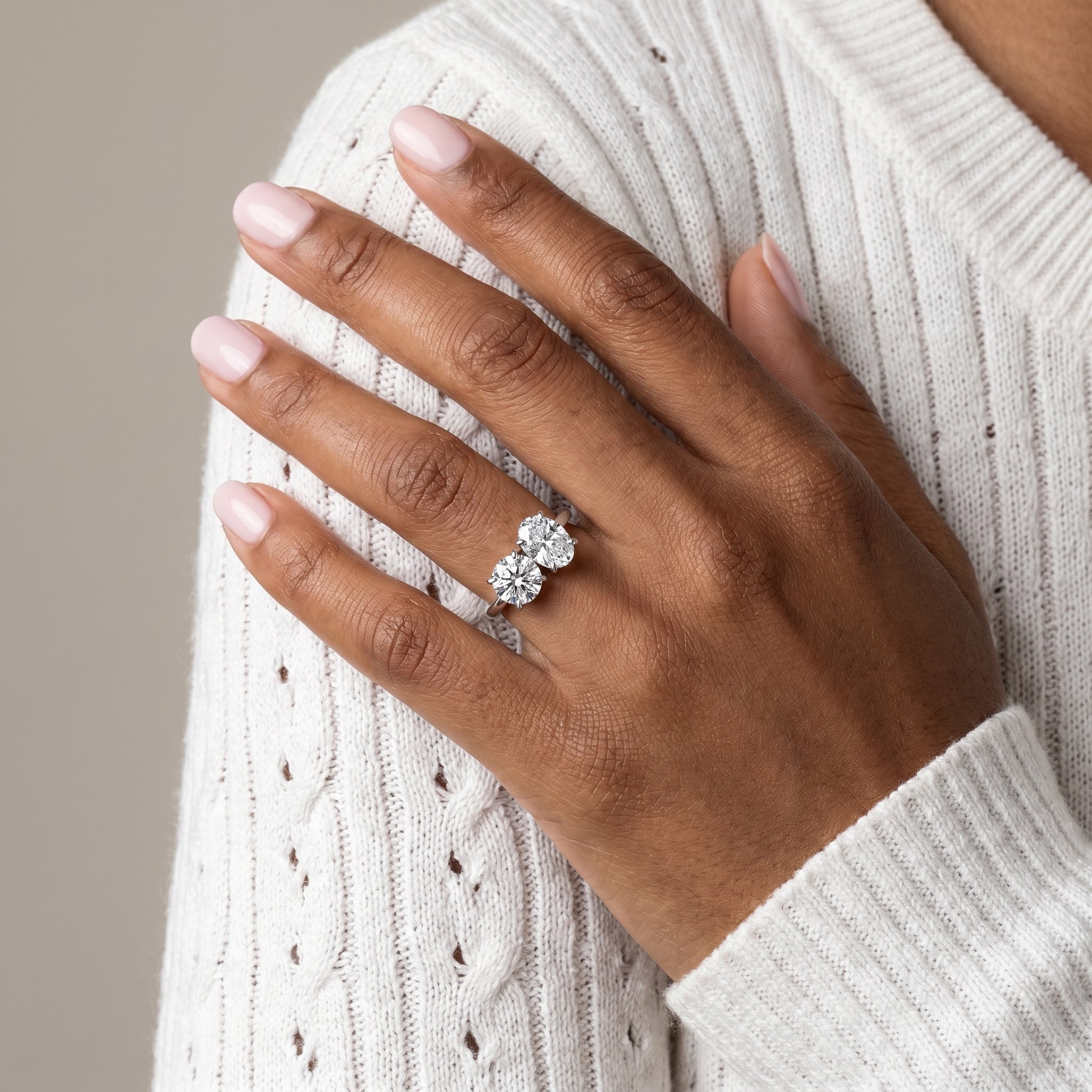 Close-up detail of dual stone moissanite ring prong setting oval and round
