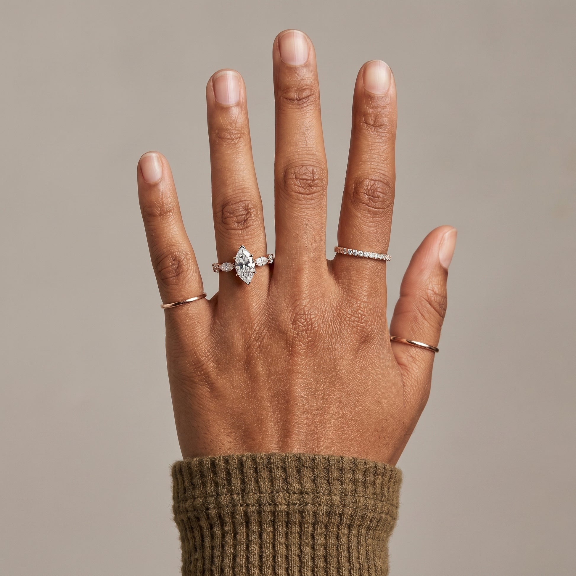 Marquise cut moissanite ring worn on hand in 925 sterling silver with hidden halo
