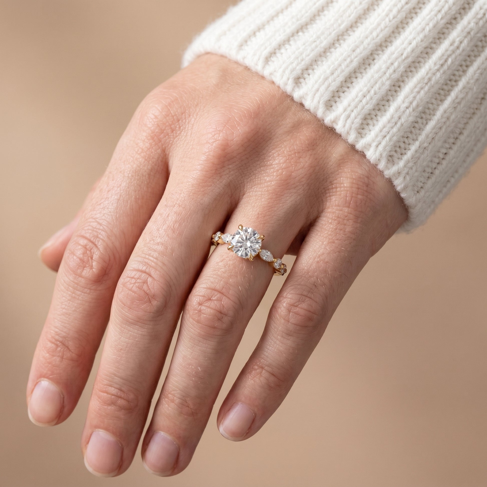 Moissanite engagement ring in yellow gold worn in natural light lifestyle setting