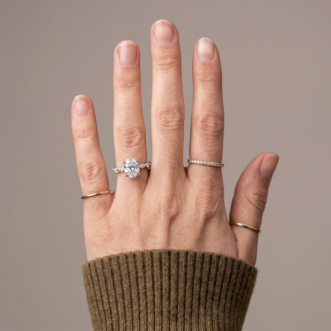Round moissanite solitaire ring with hidden halo and side stones in 925 sterling silver front view