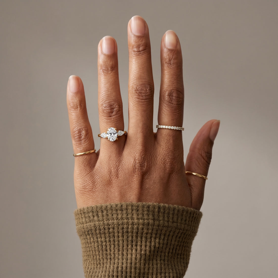 Oval moissanite three stone ring in yellow gold plated silver with pear side stones luxury engagement ring