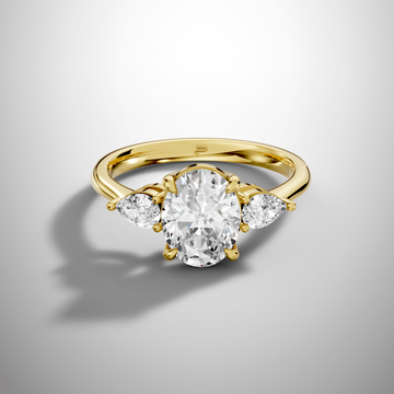 Oval moissanite three stone ring in yellow gold plated silver with pear side stones luxury engagement ring