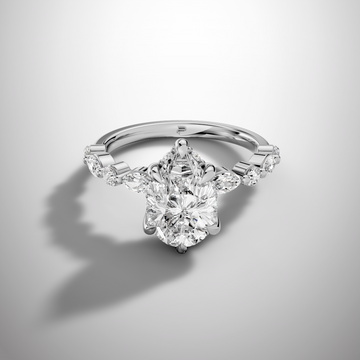 Pear cut moissanite solitaire ring with hidden halo and side stones in 925 sterling silver front view