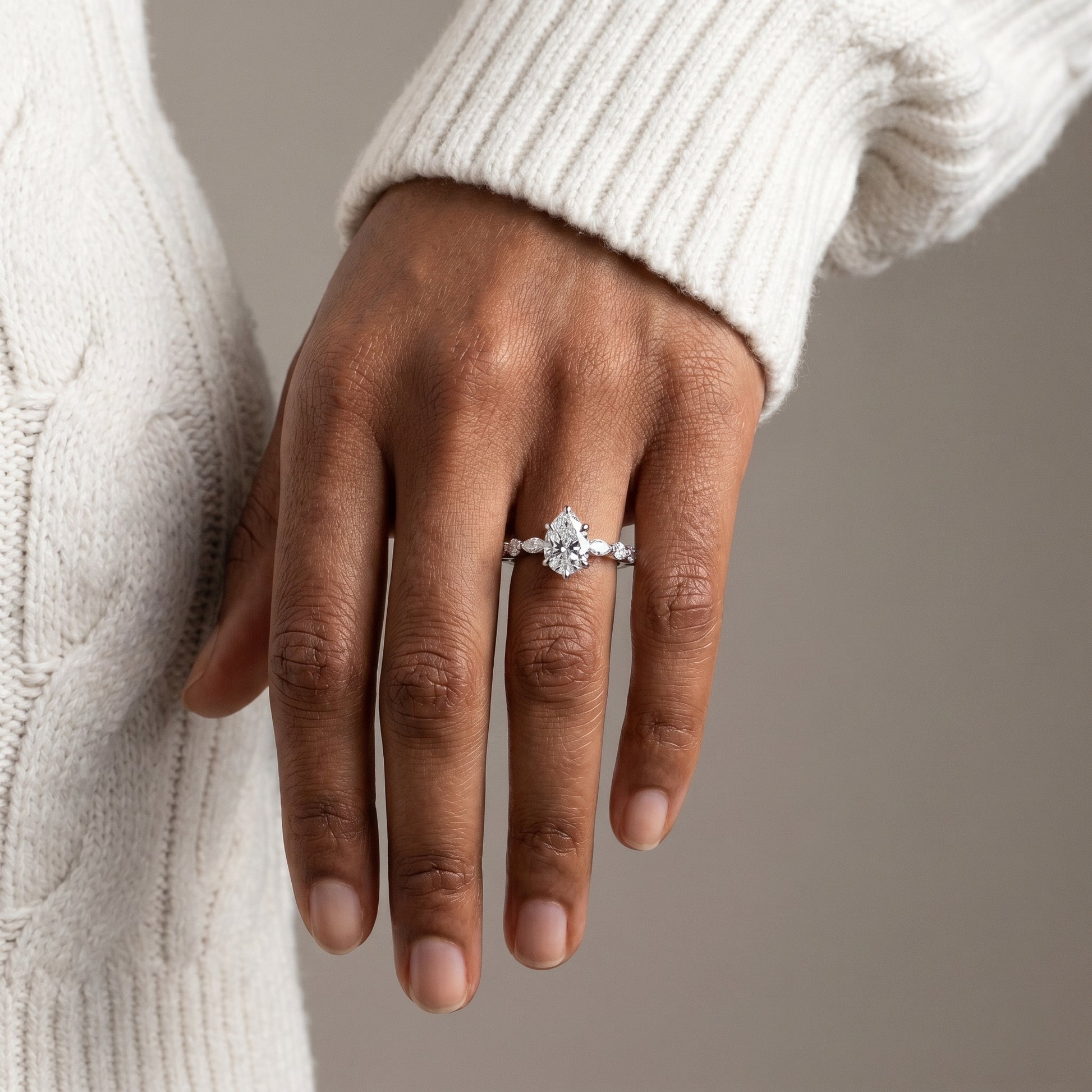 Elegant pear cut moissanite engagement ring with hidden halo in silver
