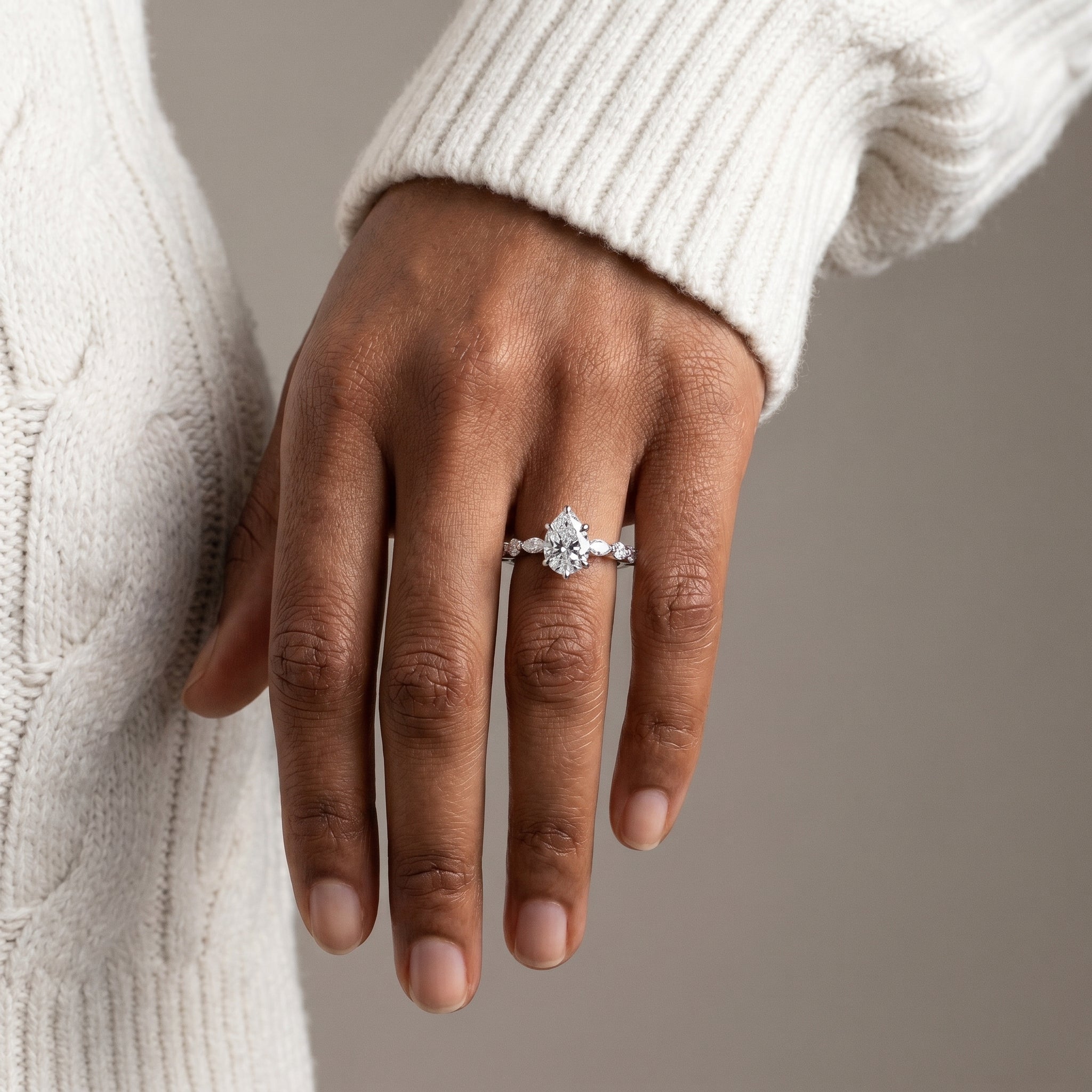 Elegant pear cut moissanite engagement ring with hidden halo in silver
