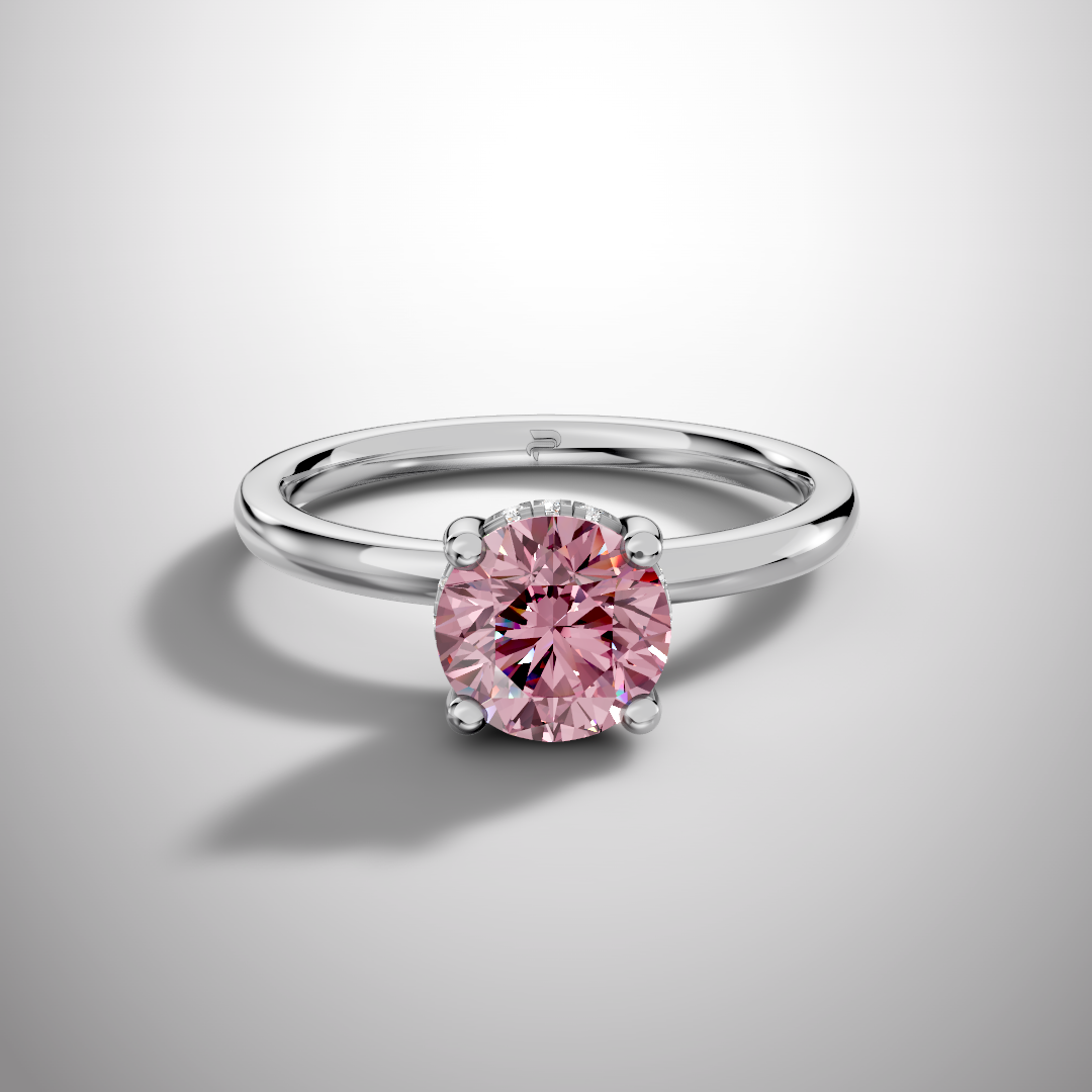 Pink round cut moissanite solitaire ring in 925 sterling silver with classic four prong setting