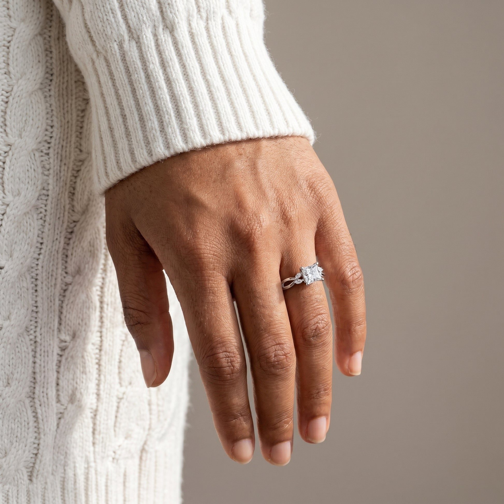 close up princess cut moissanite infinity ring on hand 925 silver