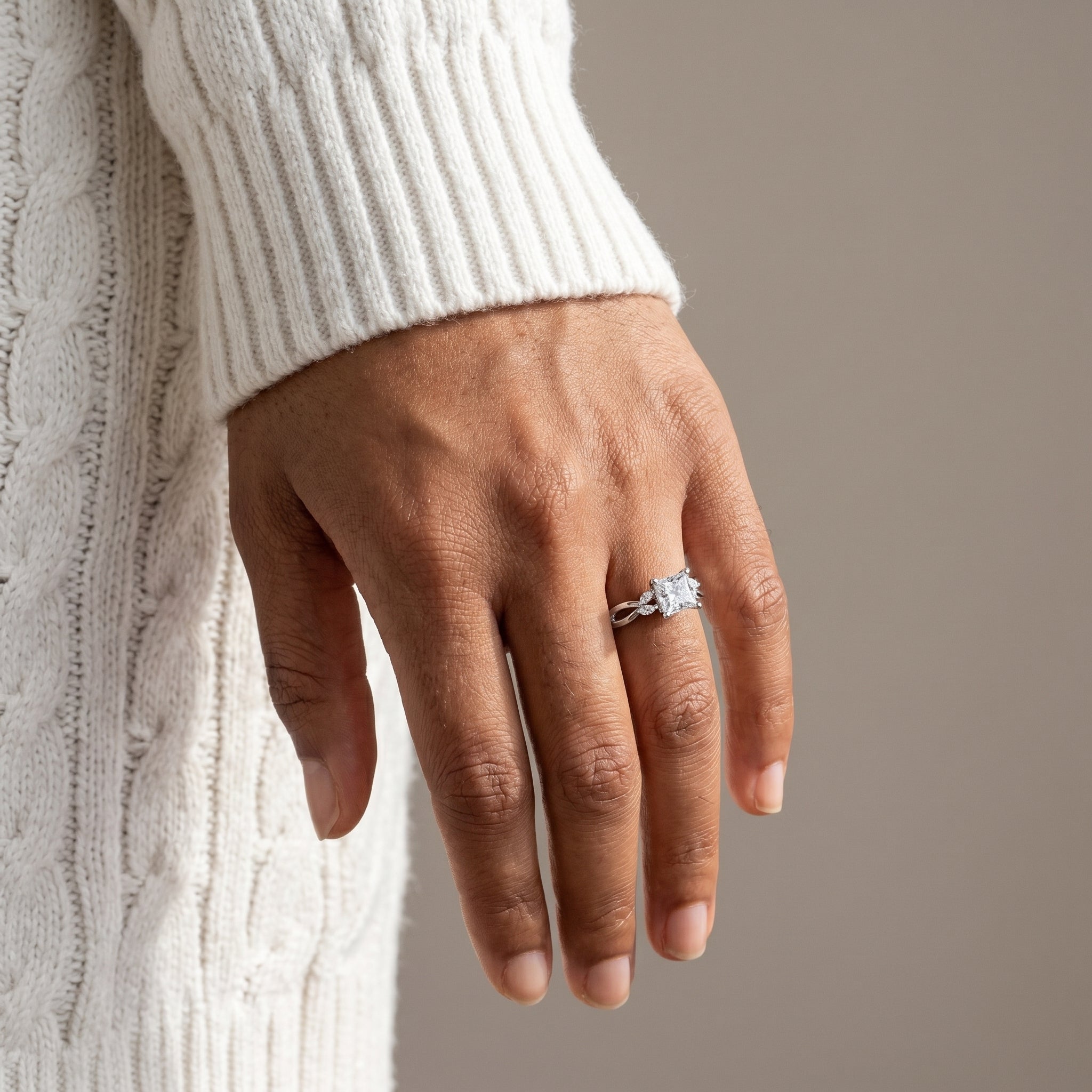 close up princess cut moissanite infinity ring on hand 925 silver