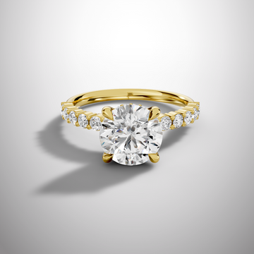 Round moissanite solitaire engagement ring in silver with pavé side stones and elegant slim band
