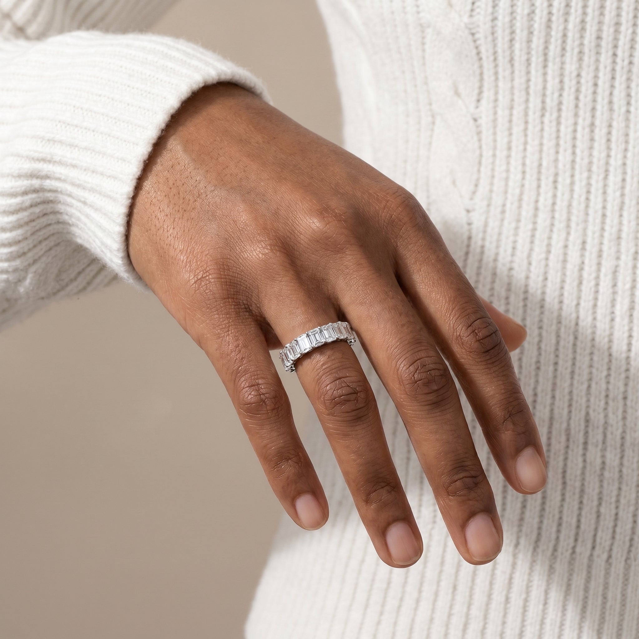 luxury silver emerald moissanite eternity ring worn by model stylish elegant jewelry