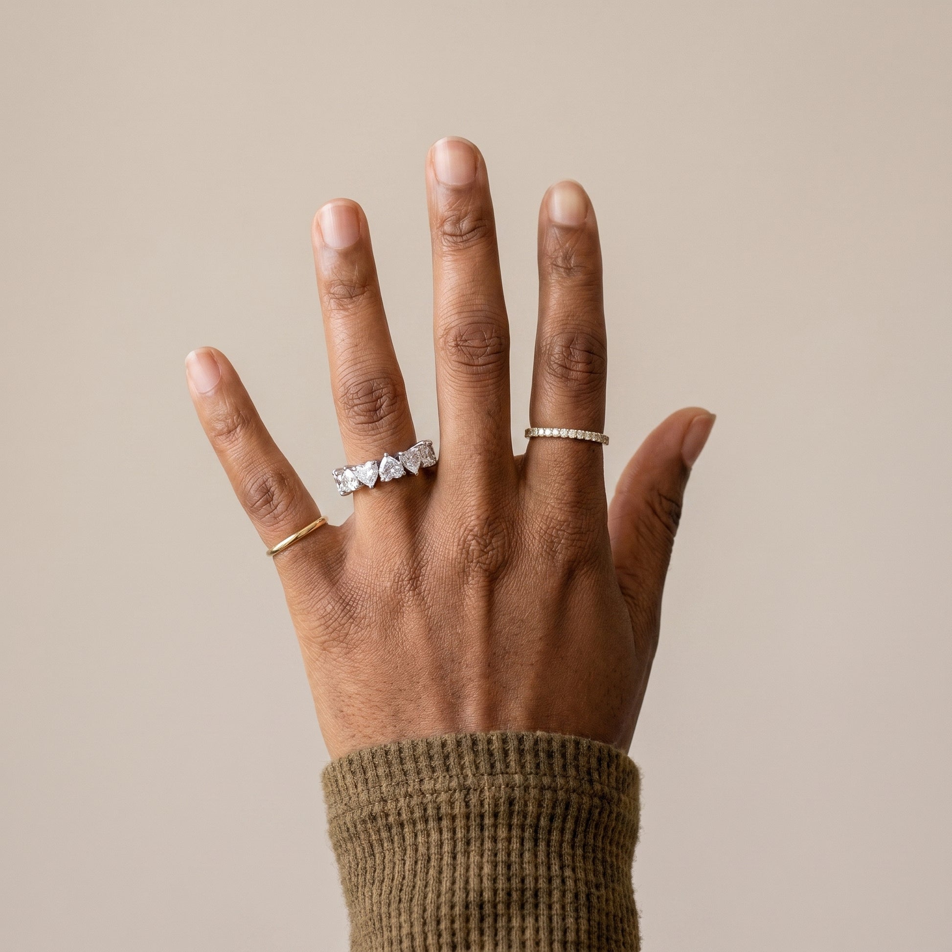 woman wearing heart moissanite eternity ring silver romantic wedding band on finger