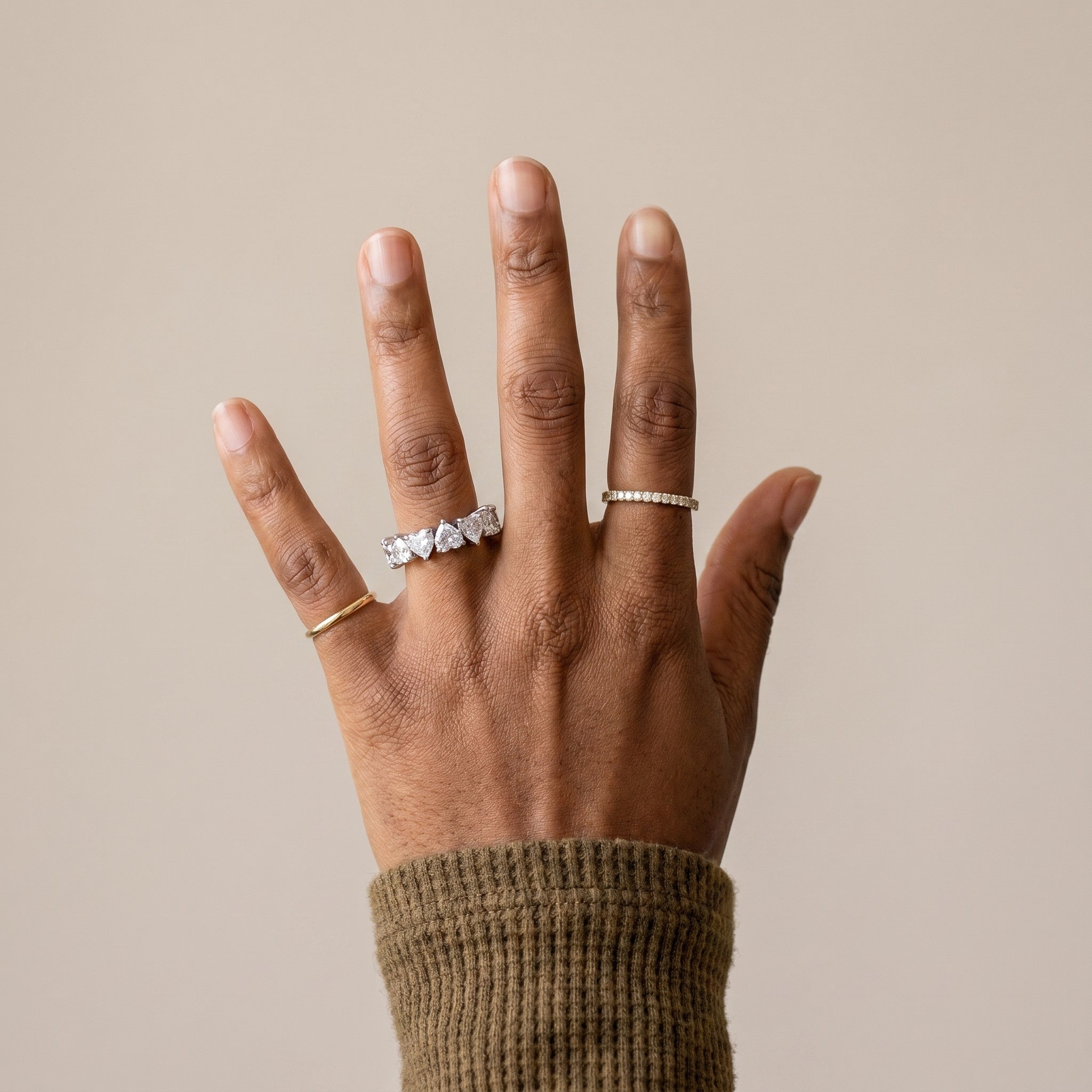 woman wearing heart moissanite eternity ring silver romantic wedding band on finger